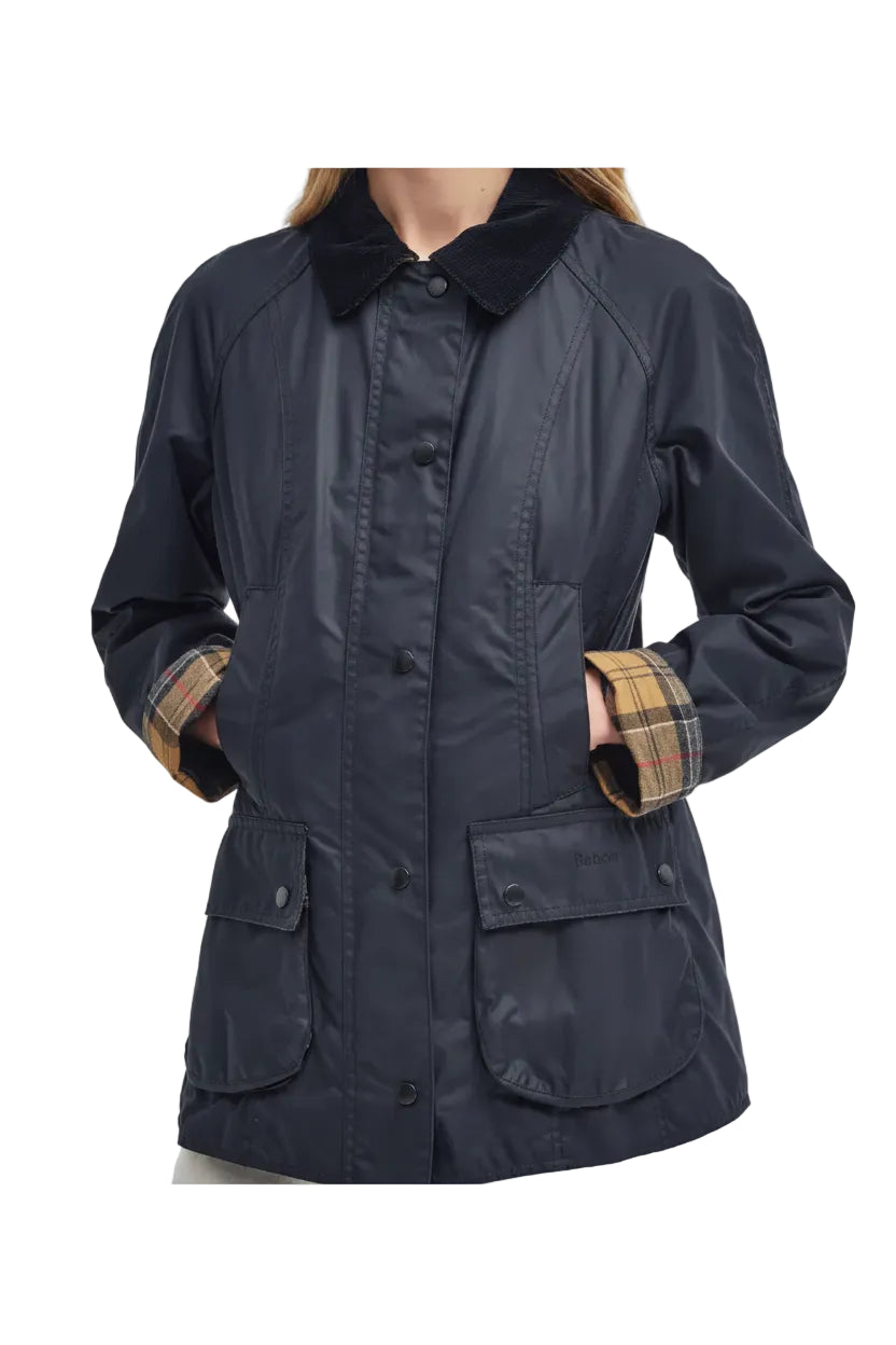 Navy women's wax jacket with plaid cuffs, front buttons, and multiple patch pockets
