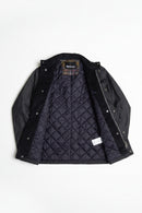 Men's navy wax jacket with quilted lining and inner plaid layer detail