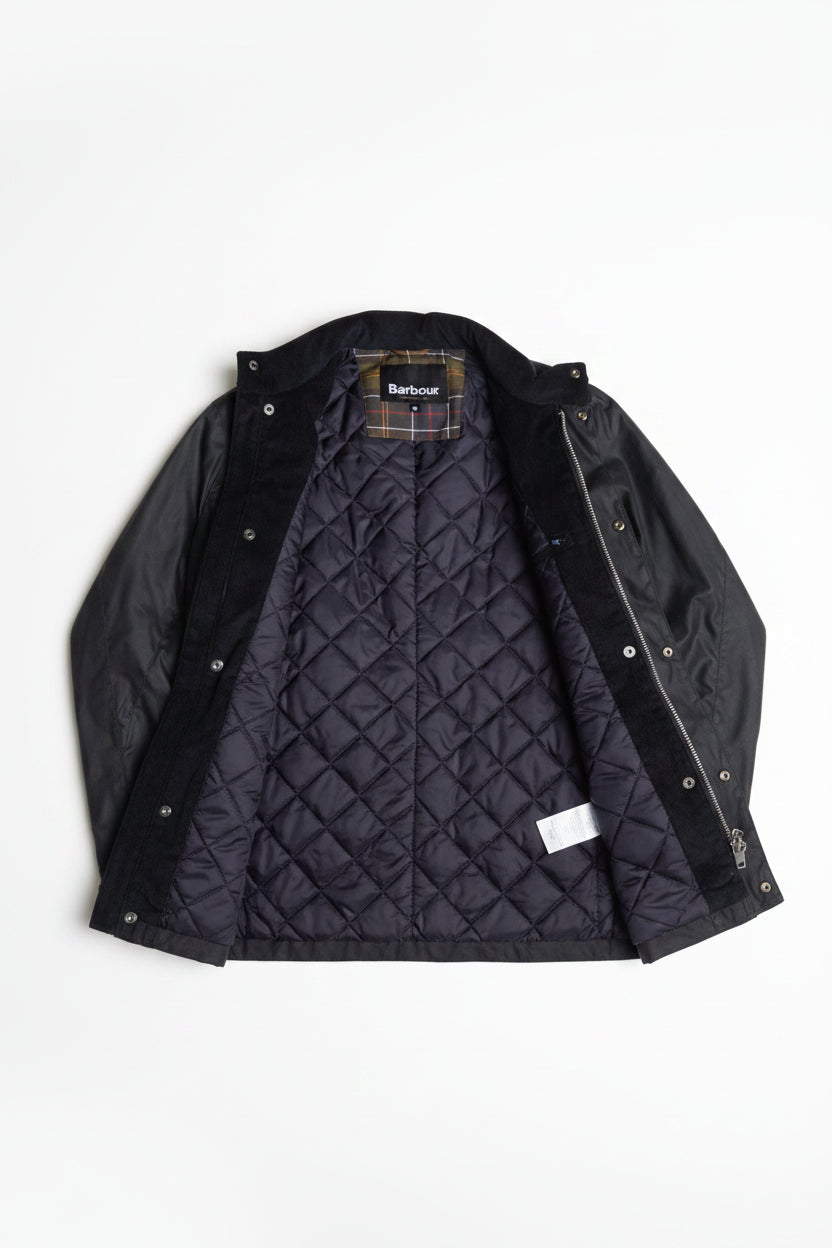 Men's navy wax jacket with quilted lining and inner plaid layer detail