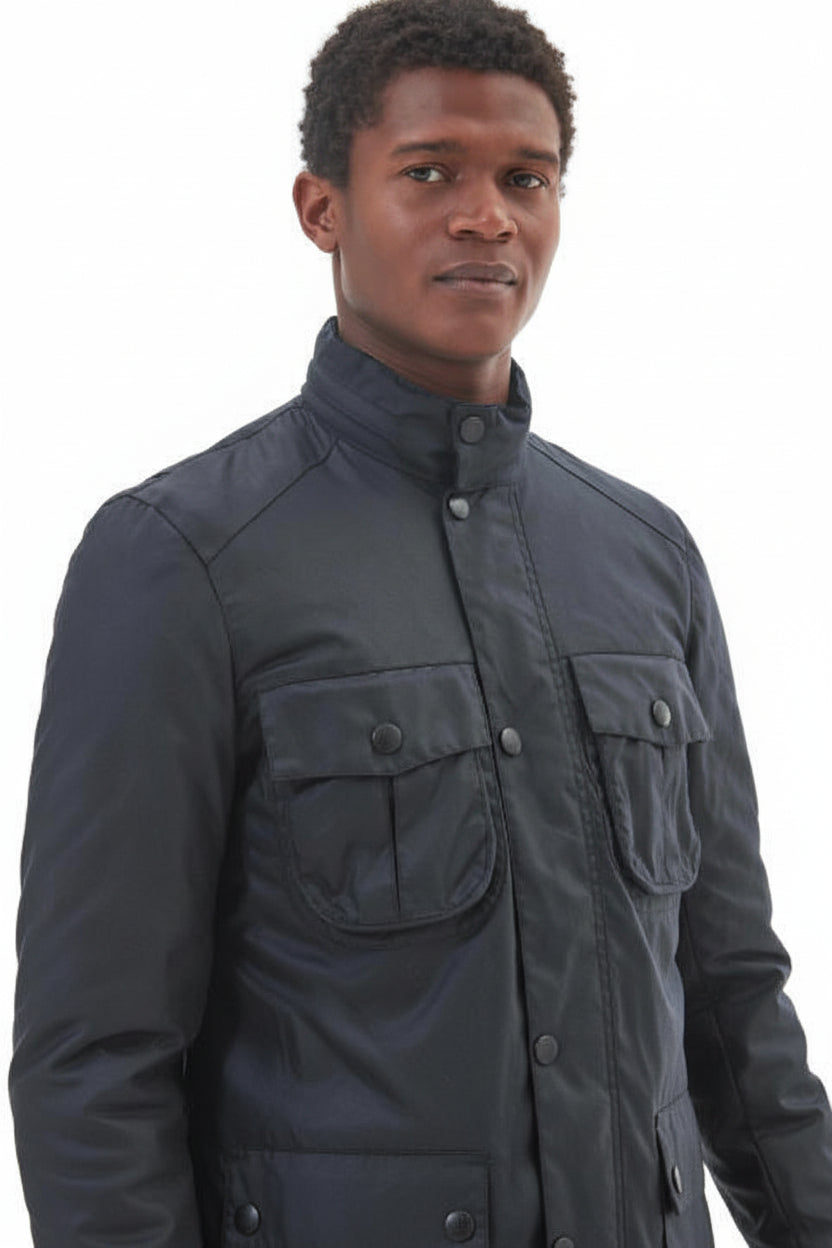Men's navy wax jacket close-up with stand collar, button placket, and chest pockets