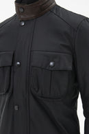 Men's navy wax jacket close-up of buttoned chest pockets and stand collar