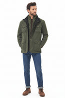 Men's olive waterproof jacket with button-front and flap pockets over denim