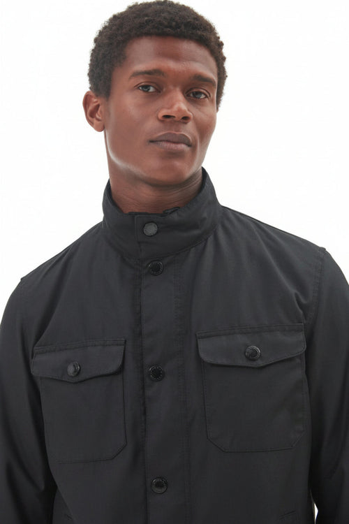 Men's black wax jacket front view with two flap pockets and button placket