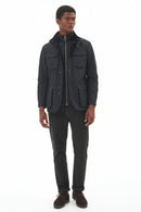 Men's black wax jacket worn over shirt with full button front and flap pockets