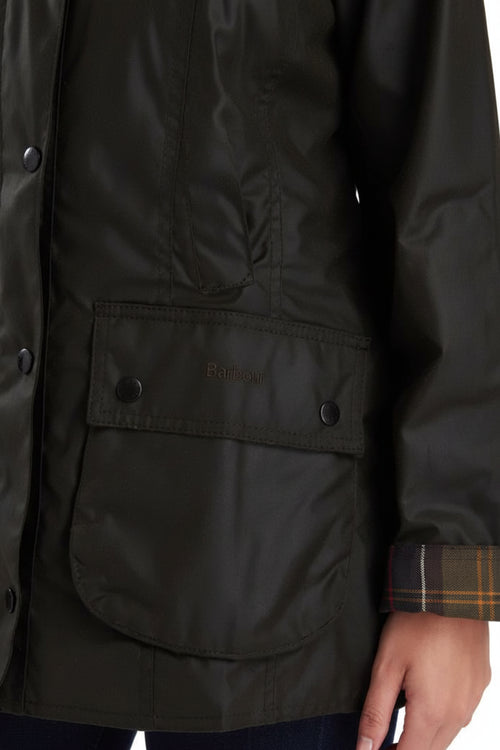 Dark olive jacket with flap pocket and plaid inner cuff detail.