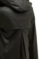 Dark olive Barbour waxed jacket chest panel with rectangular brand patch and button placket.