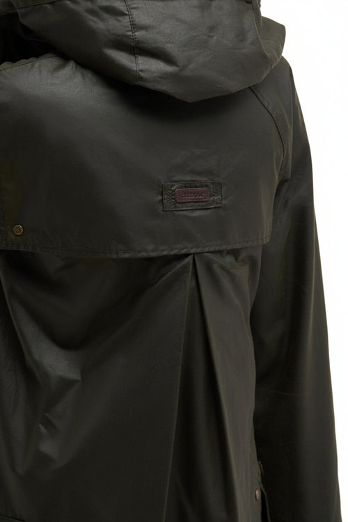 Dark olive Barbour waxed jacket chest panel with rectangular brand patch and button placket.