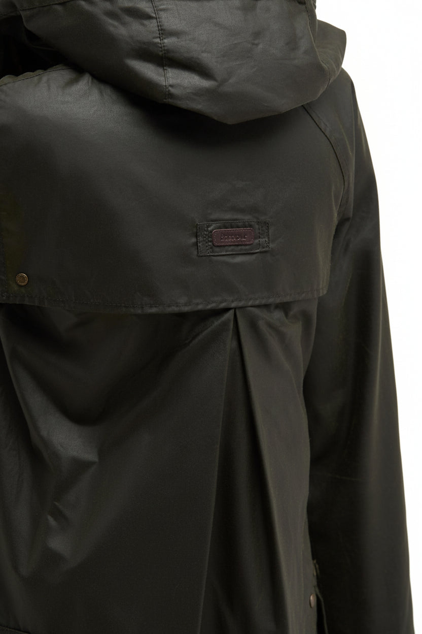 Dark olive Barbour waxed jacket chest panel with rectangular brand patch and button placket.