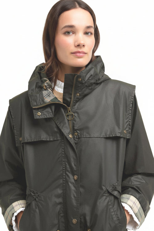 Barbour waxed jacket front with attached hood, button closure, and plaid-lined cuffs.