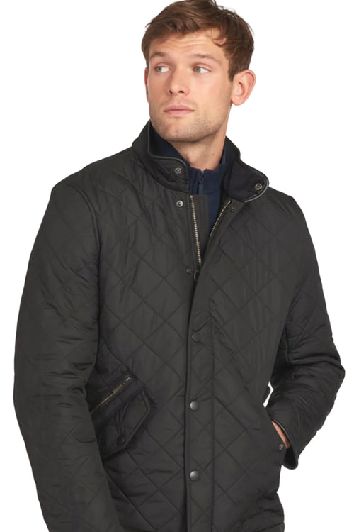 Black quilted jacket with stand collar, chest pocket, and side seam pockets