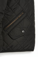 Black quilted jacket with diamond stitching, zip fly, and front snap button placket