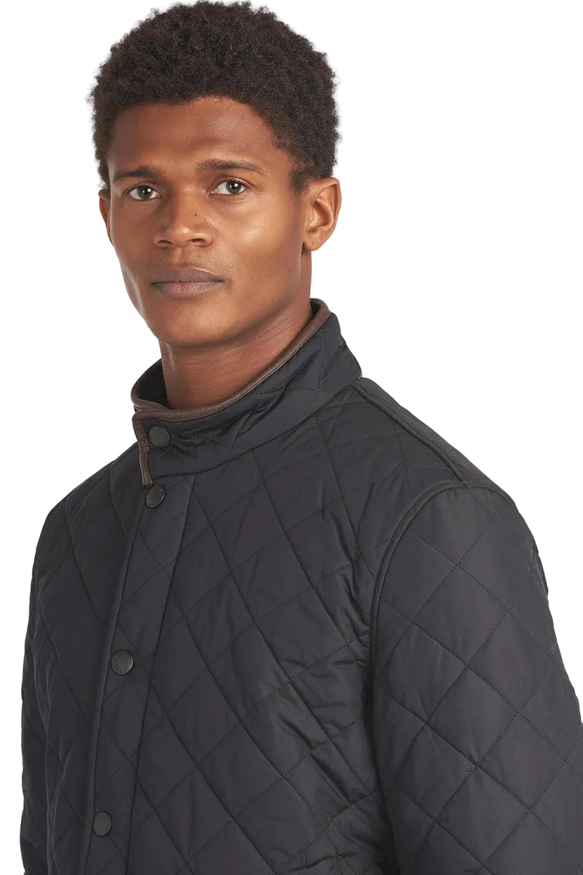 Barbour quilted jacket in dark navy with stand collar, snap buttons, and side pockets