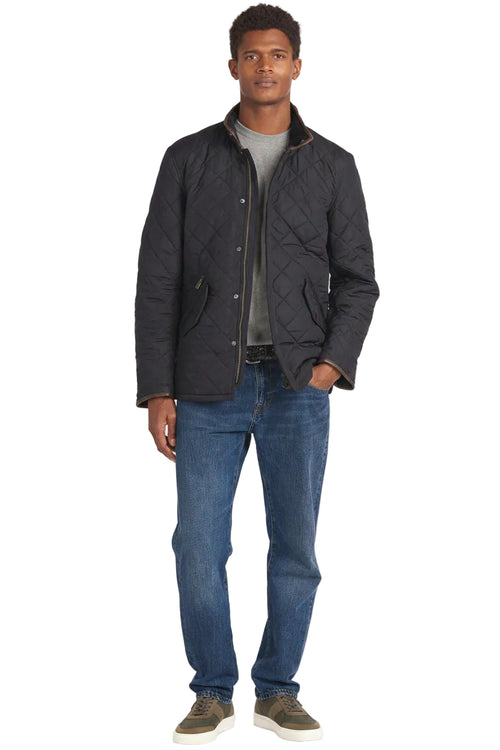 Barbour quilted jacket front on model, dark navy diamond quilting with snap front