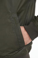 Olive waxed cotton jacket sleeve with ribbed cuff and Barbour logo patch