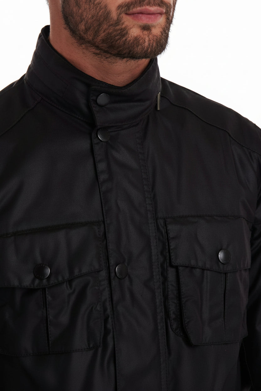 Dark wax jacket close-up with snap button flap and buttoned chest pockets