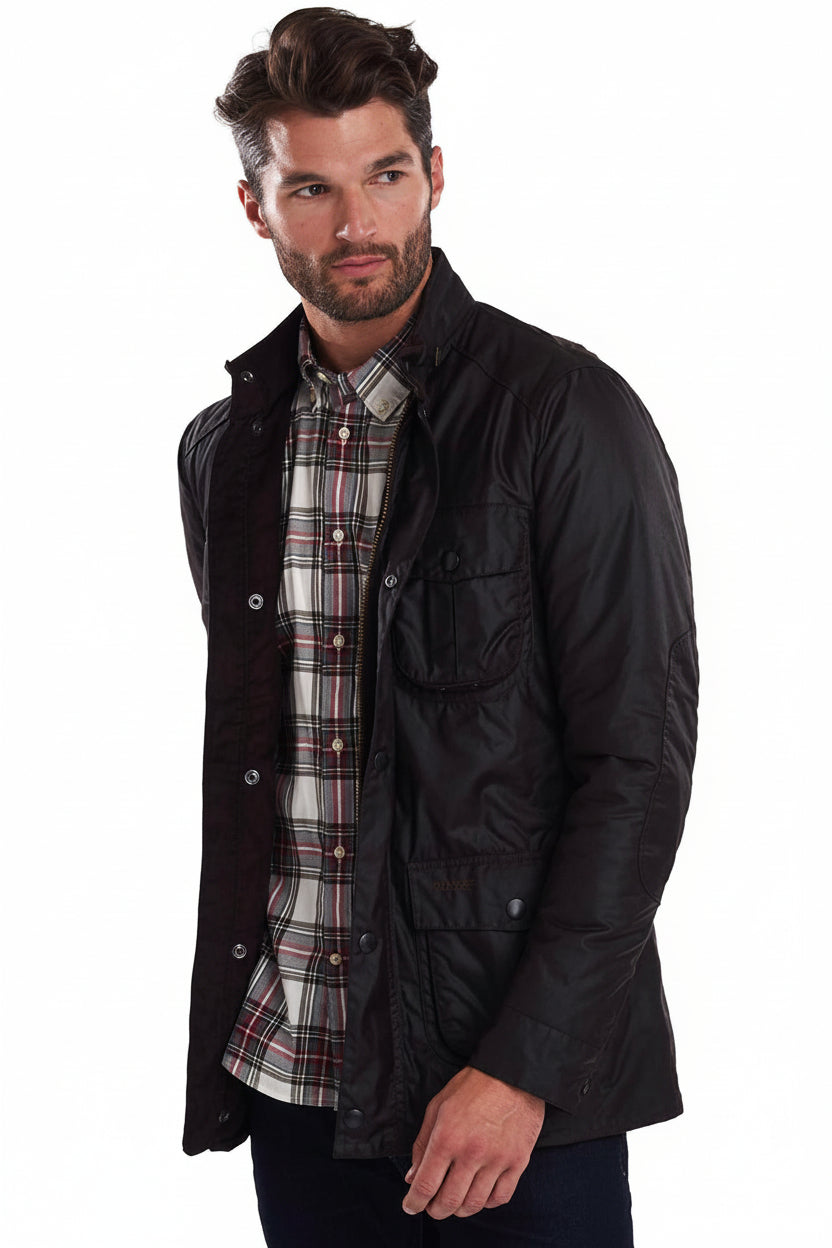 Dark wax jacket with snap pockets and plaid layer at collar