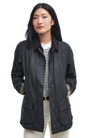 Women's black wax Beadnell jacket with drawstring hem, patch pockets, belt tabs