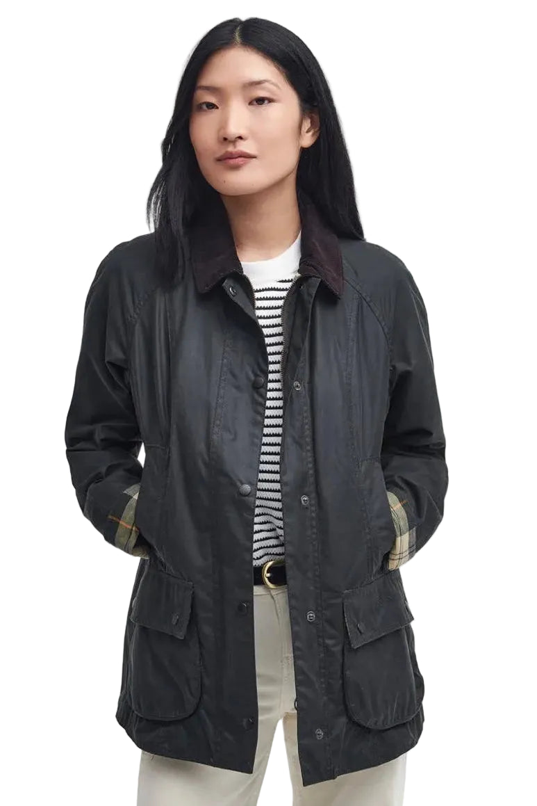 Women's black wax Beadnell jacket with drawstring hem, patch pockets, belt tabs