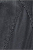 Black wax fabric close-up with stitched seam lines