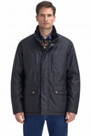 Men's waxed jacket with high collar, center zip, and flap pockets on chest and waist