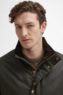 Barbour men's olive waxed jacket with zip front, brown knit collar and brass snaps