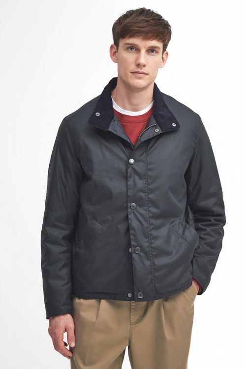 Navy wax jacket with zip front and stand collar, worn with red shirt