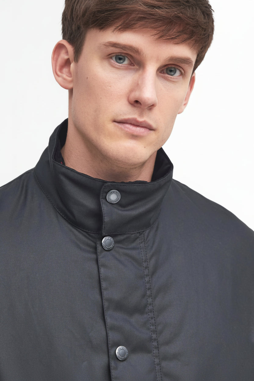 Dark navy wax jacket with high neck and button-up front