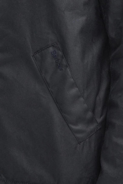 Navy wax jacket detail with chevron quilting and logo patch