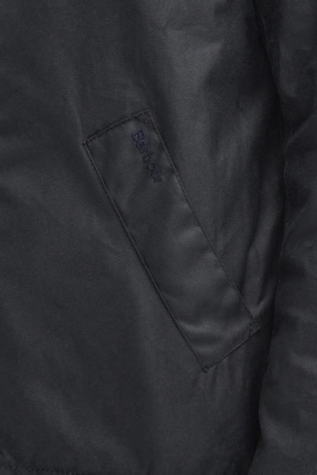 Navy wax jacket detail with chevron quilting and logo patch