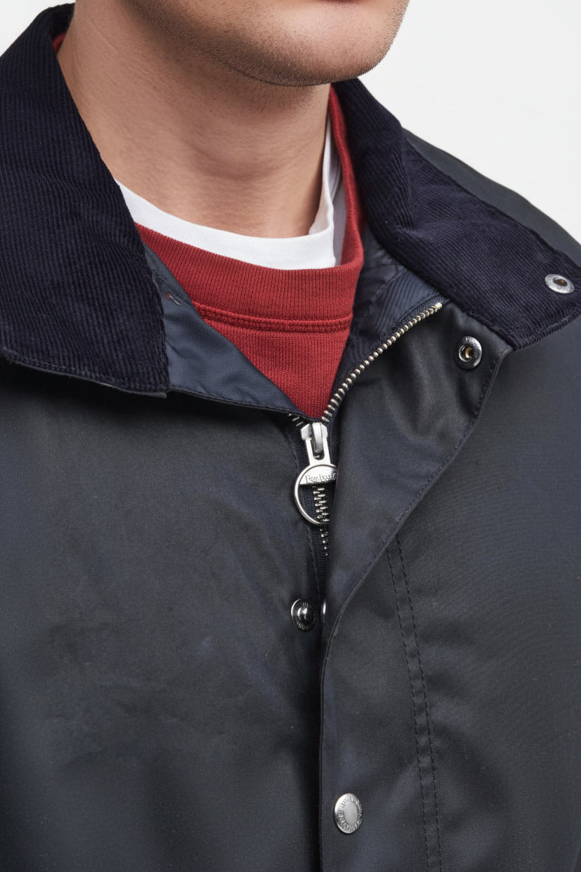 Navy wax jacket with zip front, snap buttons, and stand collar