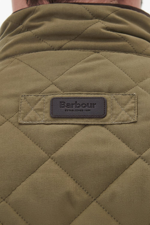 Barbour logo patch on olive quilted waterproof jacket back