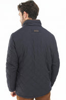 Navy quilted jacket back view with diamond stitching and stand collar