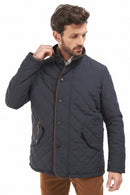 Navy quilted jacket with front snap placket and side pocket detail