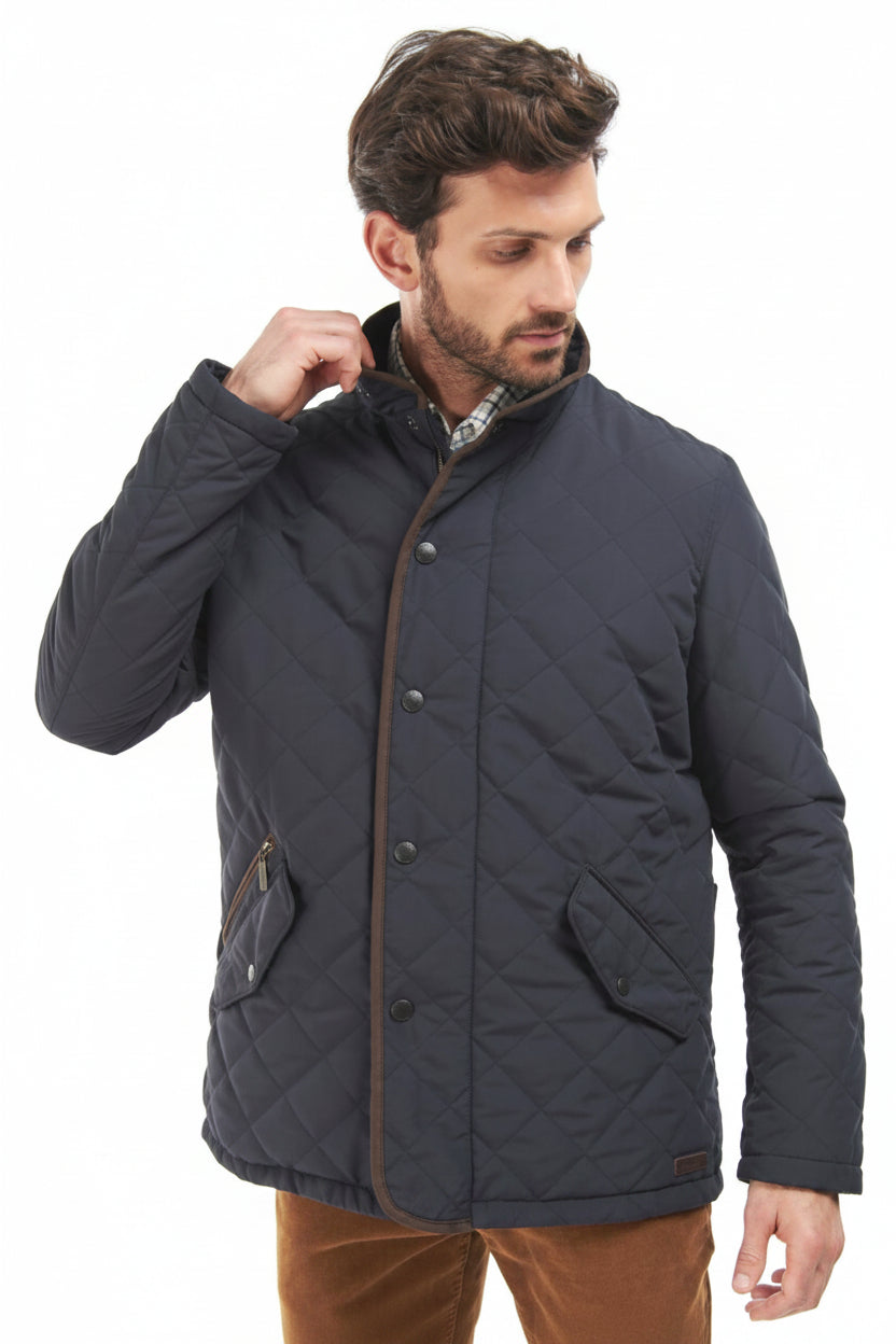 Navy quilted jacket with front snap placket and side pocket detail