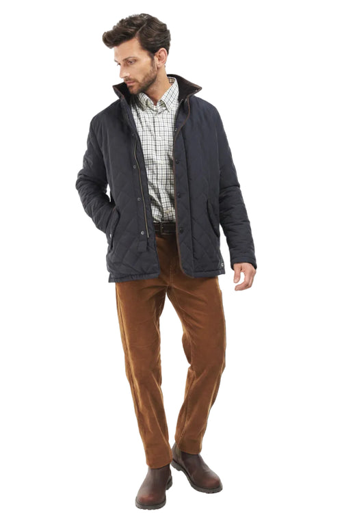 Navy quilted jacket with front snap closure and tartan inner collar