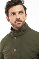 Olive quilted jacket with stand collar and snap-button front, brown inner trim
