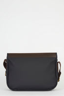 Navy messenger bag with brown leather-trim back and rounded flap edge