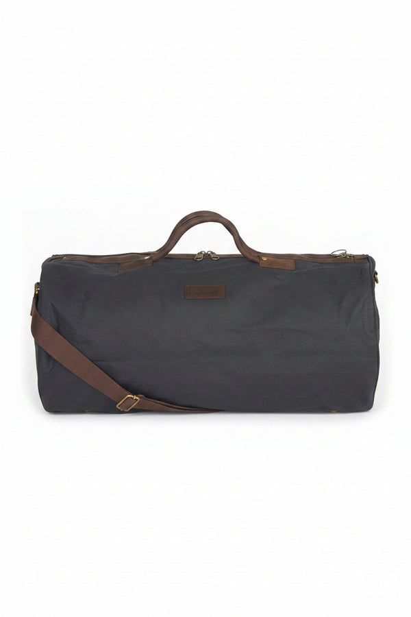 Wax holdall bag in dark navy with leather handles and shoulder strap