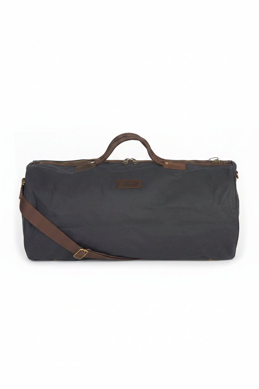 Wax holdall bag in dark navy with leather handles and shoulder strap