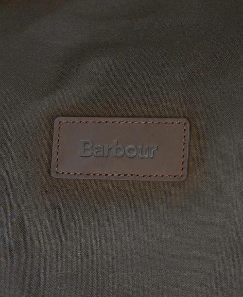 Barbour logo leather patch on olive wax holdall bag front