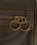 Olive holdall bag close-up with brass double ring hardware and zip detail