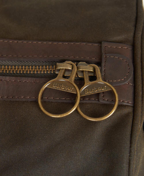 Olive holdall bag close-up with brass double ring hardware and zip detail