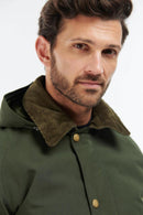 Men's sage green winter jacket close-up of corduroy-like collar and snap placket.