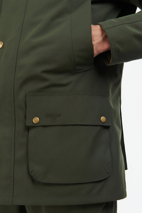 Men's sage green jacket detail: flap chest pocket with brass-tone snap buttons.