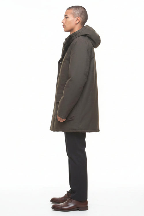 Barbour Beaufort waterproof parka, side profile with long hood and flap pockets, dark olive.