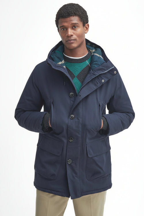 Navy waterproof parka with hood, front pockets, and snap-button closure.