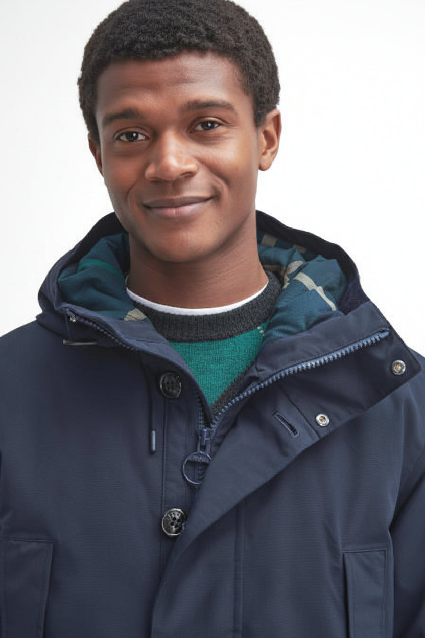 Navy waterproof parka hood with plaid inner trim and snap-front neckline.