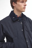 Navy Bedale jacket close-up: stand collar, button placket, chest pocket flaps