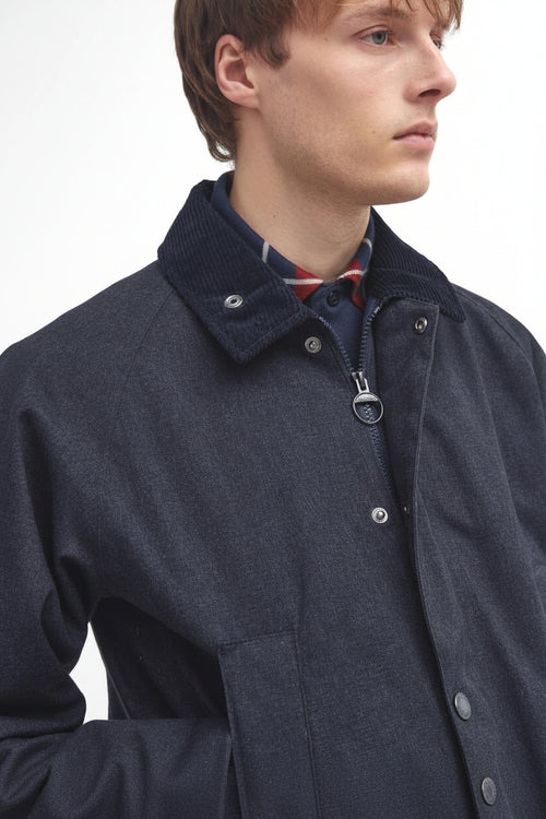 Navy Bedale jacket close-up: stand collar, button placket, chest pocket flaps