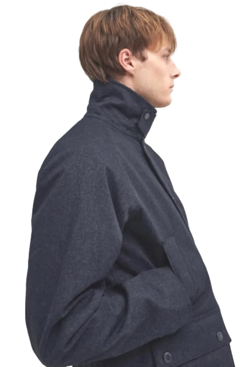 Navy waterproof Bedale jacket side view, stand collar, buttoned storm flap